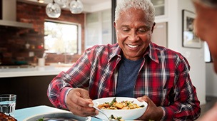 man eating dinner with his wife