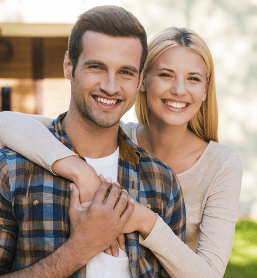 Man and woman smiling after visiting Lakewood dentist