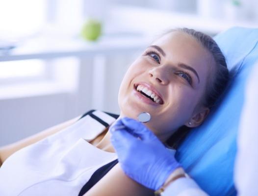 Woman in dental smiling at dentist