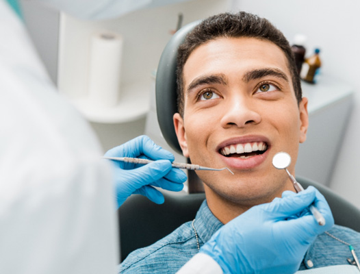 a man having his teeth examined at the dental office