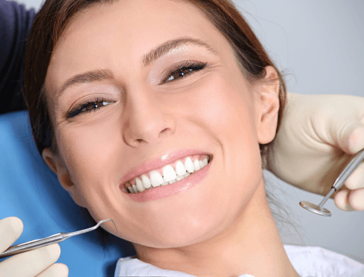 Woman smiling during dental treatment