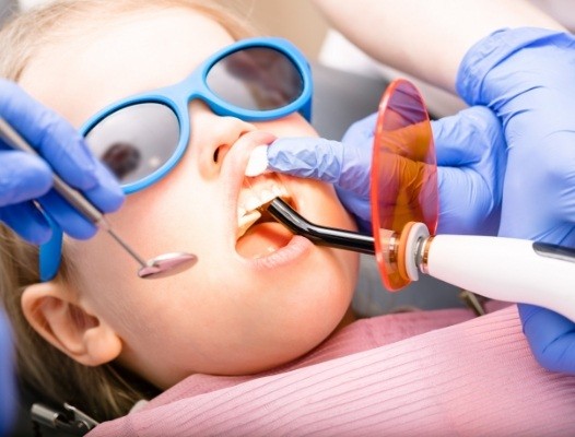 Child receiving dental sealants