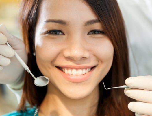 Woman receiving professional teeth cleaning