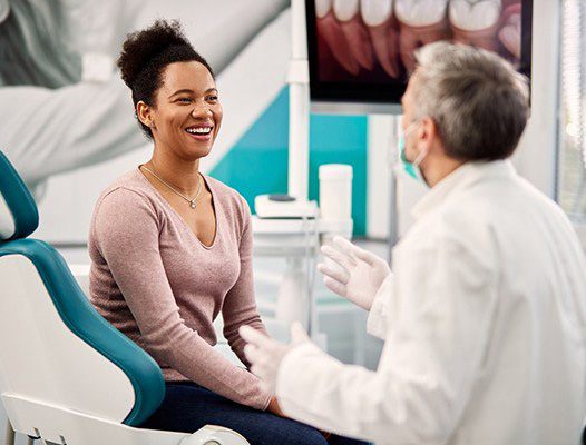 Woman talking with dentist in DuPont