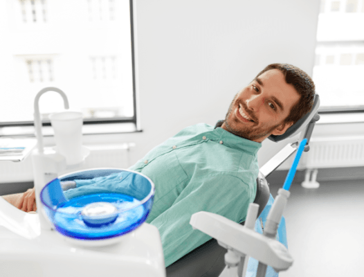 Man in dental chair smiling