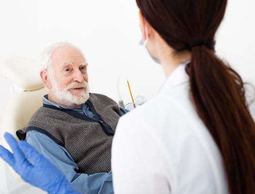 Patient listening to emergency dentist in DuPont