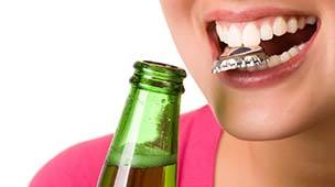 Woman with bottlecap between teeth headed for dental emergency in Dupont