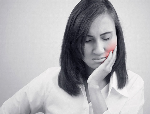 Woman with tooth pain in Dupont