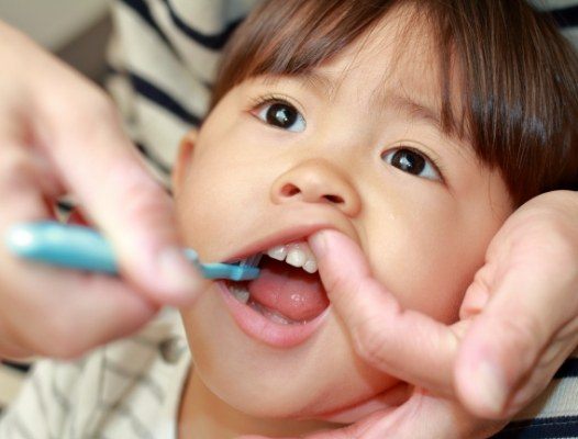 Dentist examining child's smile