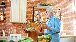 Older couple making a salad in DuPont