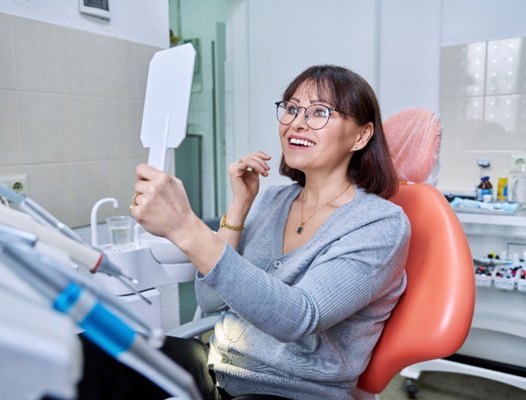 Woman with implant dentures in DuPont