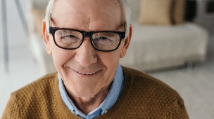 Man smiles after dental implant placement in DuPont