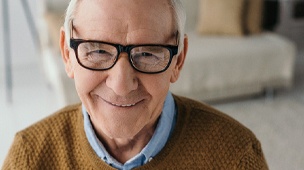 Man smiles after dental implant placement in DuPont