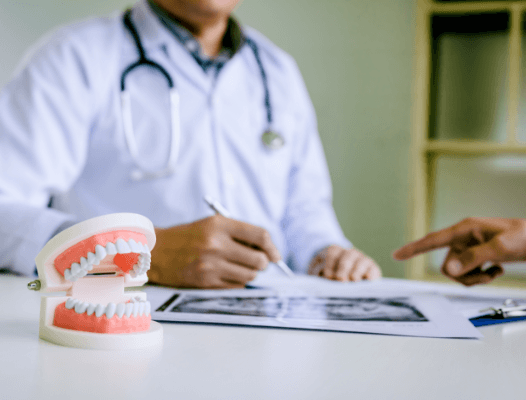 Dentist looking at x-rays and smile model