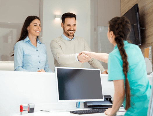 Dental team members checking in at reception desk