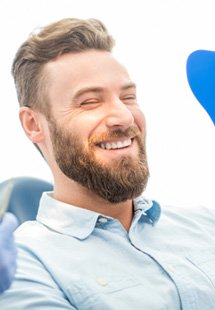 man smiling while visiting dentist 