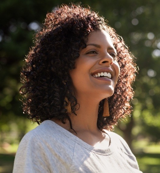Woman with metal free dental crowns smiling