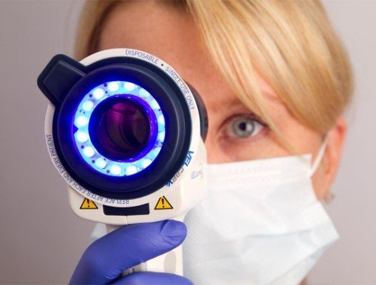 Dentist using oral cancer screening light