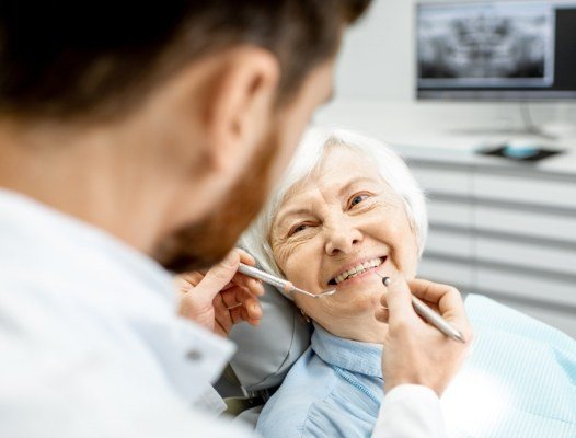 Older woman smiling during oral cancer screening
