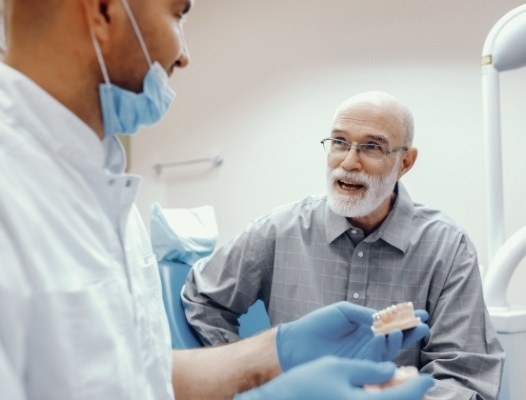 Man with partial denture talking to dentist