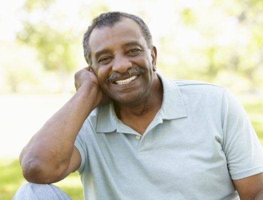 Man with implant retained partial denture smiling