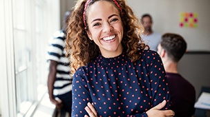 woman smiling with her arms crossed