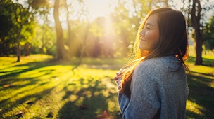 a peaceful woman taking a walk in a park