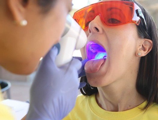 Dentist performing oral cancer screening