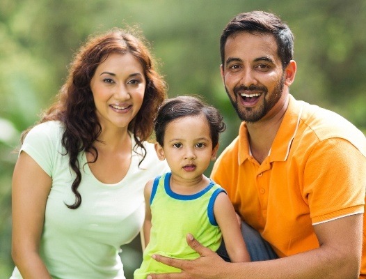 Mother father and child smiling after family dentistry