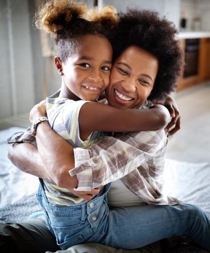 Mother hugging child after children's dentistry visit