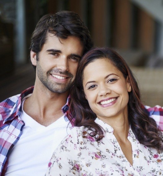 Man and woman smiling after dental care