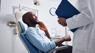 a man talking to his dentist about removing a wisdom tooth