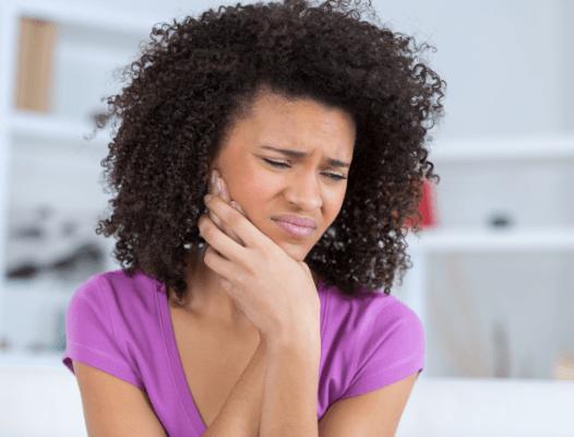 Woman in pain before wisdom tooth extraction