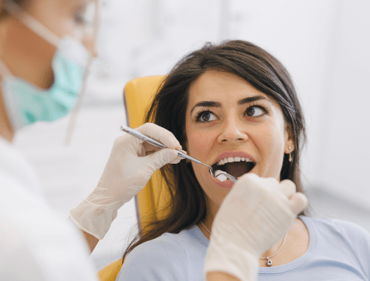 Dentist examining patient after wisdom tooth extractions