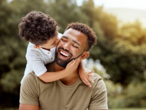 a father and son smiling