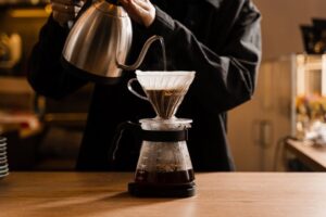 a person brewing coffee in their kitchen