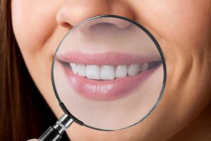 a magnifying glass over a person's teeth