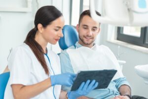 a dentist explaining a procedure to a patient