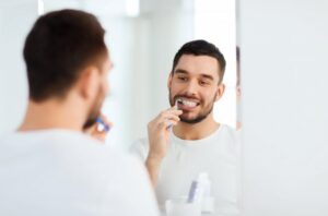 a man brushing his teeth 