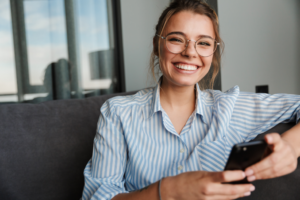 smiling woman holding her phone